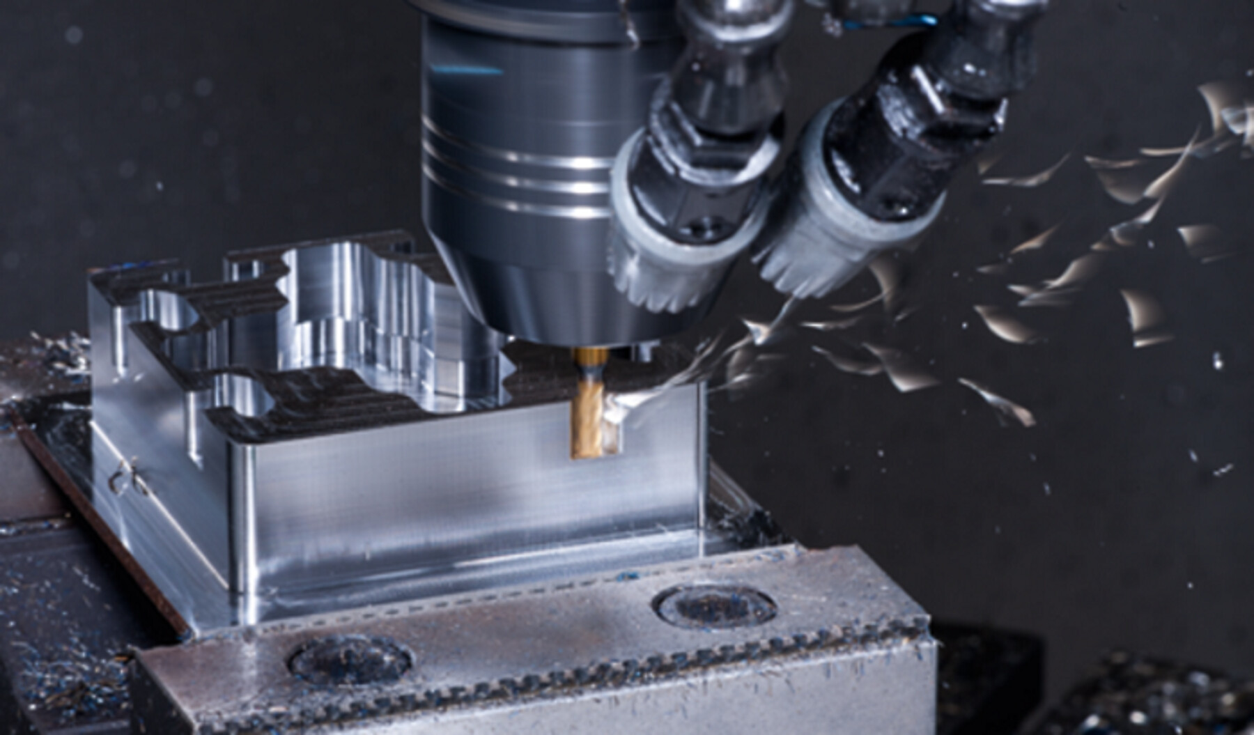 CNC milling machine cutting an aluminum part, representing industrial equipment maintenance